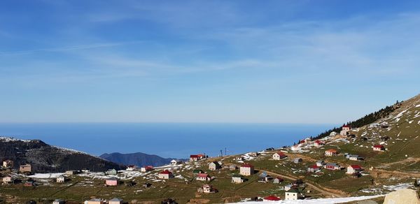 High angle view of townscape by sea against sky