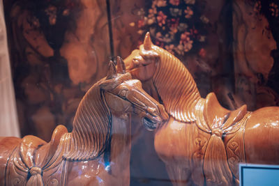 Horse statues seen through window