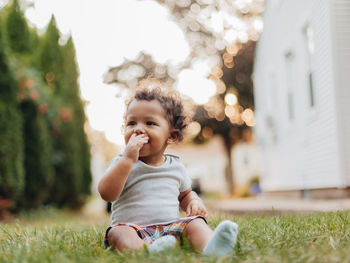Portrait of diverse mixed race baby boy at home in backyard with golden hour sunset