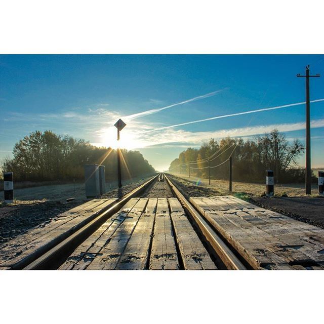 railroad track, transfer print, the way forward, transportation, diminishing perspective, rail transportation, sky, tree, vanishing point, auto post production filter, electricity pylon, power line, sunset, bare tree, connection, railway track, long, outdoors, nature, no people