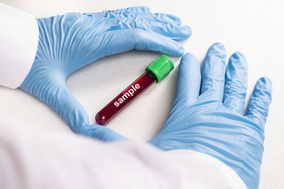 High angle view of hands on bed