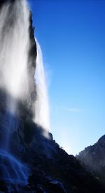 Low angle view of waterfall against sky