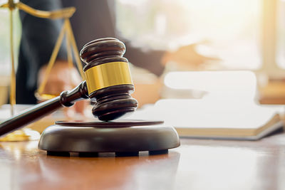 Close-up of gavel on table in courtroom