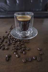 Close-up of coffee beans in glass on table