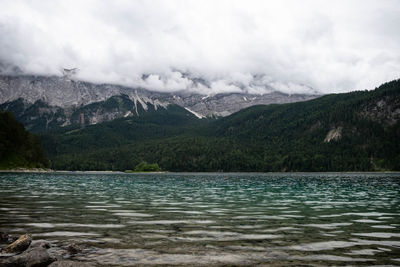 Scenic view of lake and mountains against sky