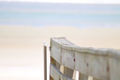 Close-up of metal structure on beach against sky