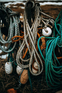 Close-up of buoys hanging at harbor