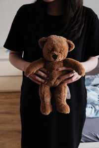 Midsection of woman with stuffed toy