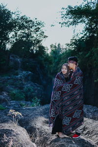 Man and woman on street amidst trees