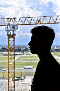 Portrait of young man standing against sky