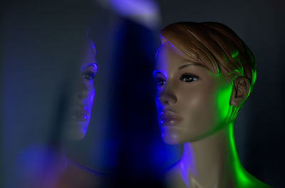 Close-up portrait of illuminated lighting equipment against black background