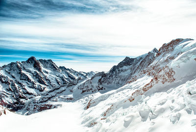 Scenic view of snowcapped mountains against sky