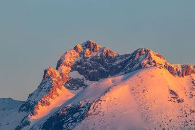 Scenic view of snowcapped mountains against clear sky during winter