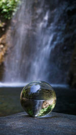 Close-up of water ball on rock