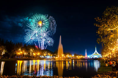 Firework display over river at night