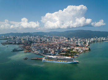 High angle view of harbor and city against sky