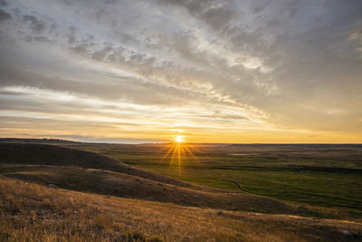 Scenic view of field against sky during sunset