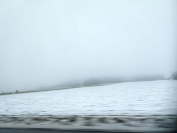 Scenic view of lake against sky during winter