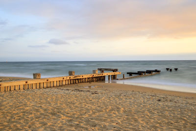 Scenic view of beach against sky during sunset