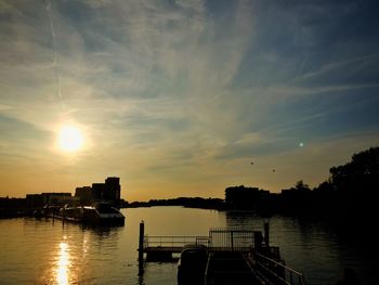 Scenic view of river against sky during sunset