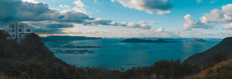 Panoramic view of sea and buildings against sky