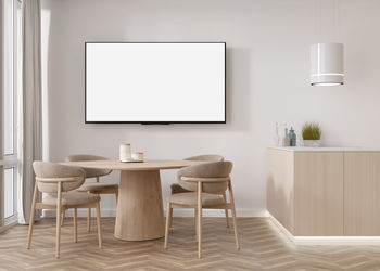 Led tv with blank white screen, hanging on the wall at home. tv mock up. copy space for advertising