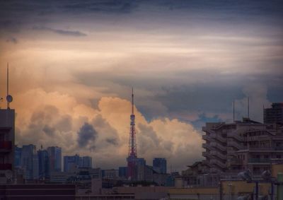 View of cityscape against dramatic sky