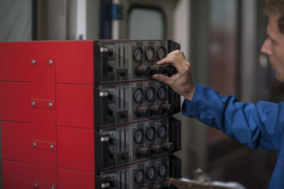 Factory worker in truck manufacture operating control panel