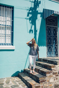 Woman standing against brick wall