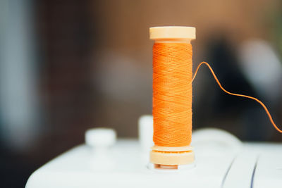 Close-up of thread on sewing machine at workshop