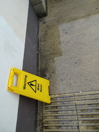 High angle view of yellow sign on road