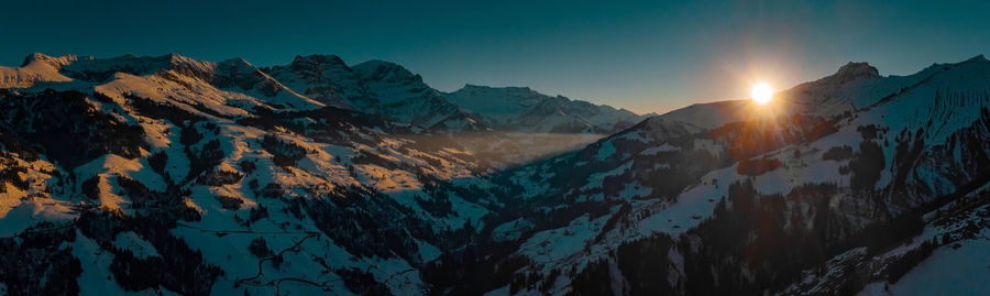 Panoramic view of snowcapped mountains against sky