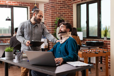 Co workers having discussion at office