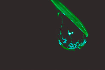 Close-up of illuminated lighting equipment against black background