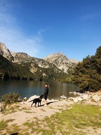 Woman with dog in the lake