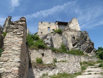 Low angle view of old ruin building against sky