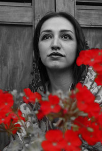 Portrait of woman with red flowers