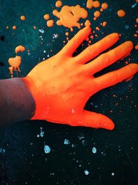 Close-up of woman hand holding multi colored water