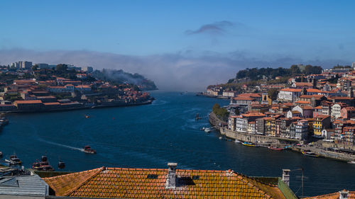 High angle view of cityscape by sea against sky