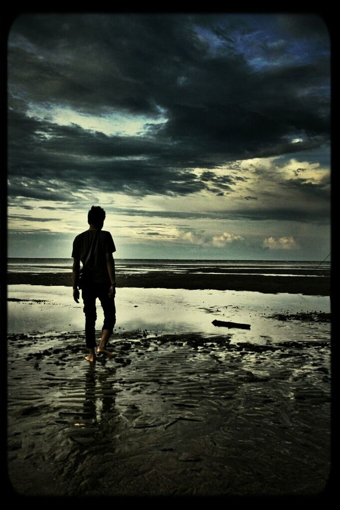 water, sea, beach, horizon over water, sky, transfer print, shore, lifestyles, leisure activity, sand, men, full length, auto post production filter, cloud - sky, standing, scenics, tranquil scene, tranquility, rear view