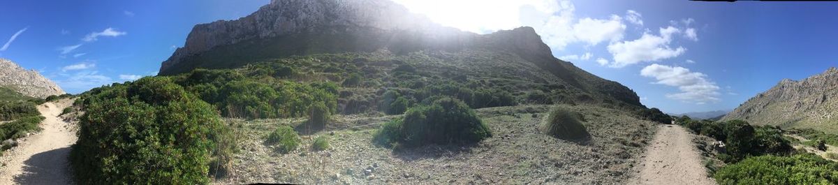 Panoramic view of mountains against cloudy sky