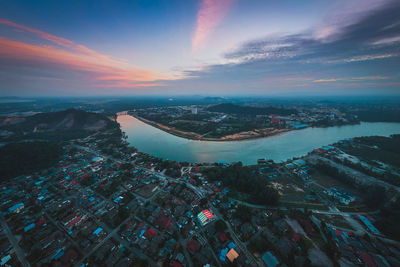 High angle view of buildings by sea against sky