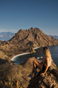 Side view of woman in mountains against clear sky