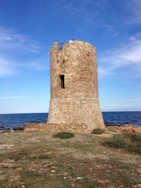 Built structure by sea against clear sky