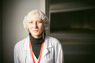 Female doctor standing in hospital lobby