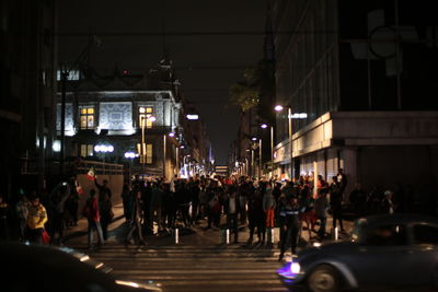 Group of people on road in city at night