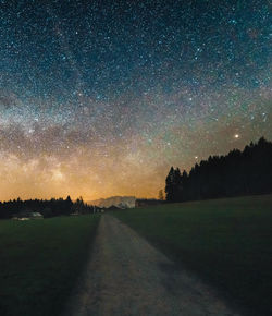 Scenic view of field against sky at night