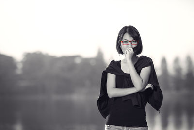 Portrait of woman standing against sky