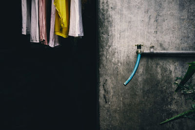 Clothes drying by wall with faucet