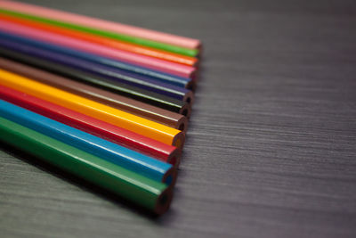 Close-up of multi colored pencils on table